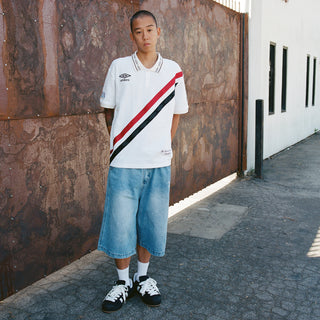 Light blue denim carpenter shorts worn by a man, with belt loops and pockets