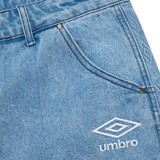 Light blue denim side pocket detail with Umbro logo patch and stitching
