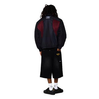 Men's black denim carpenter shorts, back view with small Umbro logo patch