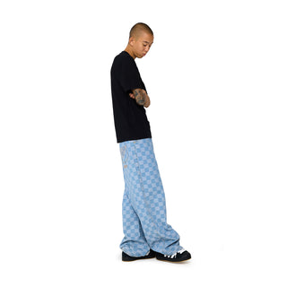 Men's light blue checker denim pants, angled side view with loose fit