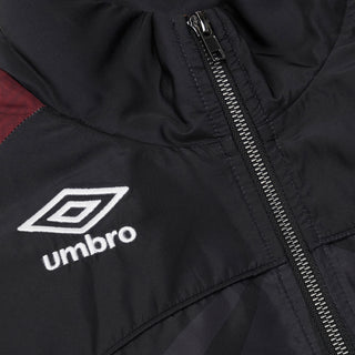 Close-up of black windbreaker jacket with Umbro logo and silver zipper