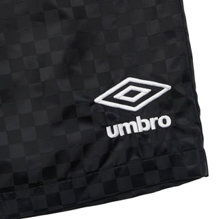 Black checkered nylon shorts with white Umbro logo patch