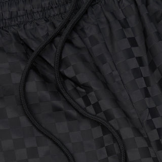 Black checkered nylon shorts, close-up of braided drawcord