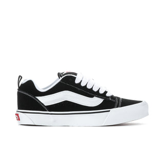 Men's black-and-white low-top lace-up sneakers with white midsole and stripe panel