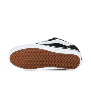 Men's sneaker outsole view, black upper with white sole and textured gum tread