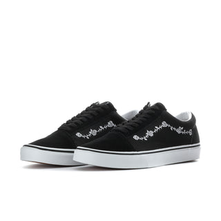 Pair of men's black low-top sneakers with white floral embroidery and white rubber soles