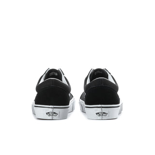 Men's black low-top sneakers, heel view with white branding patch and white rubber sole