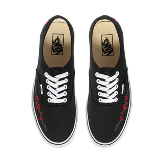 Men's black canvas sneakers front view with white laces and rose embroidery