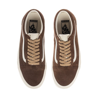 Pair of women's brown sneakers with beige laces and white-trimmed inner lining.