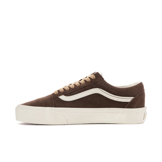 Women's brown low-top sneakers with white side stripe, lace-up closure, thick sole.