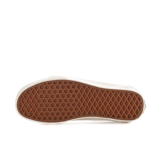 Women's brown outsole with diamond tread pattern on white sneaker sole.