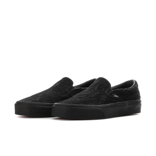 Women's black slip-on sneaker with lace-like upper texture and padded collar