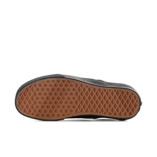 Women's black slip-on sneaker outsole with brown traction tread