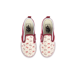 Toddler slip-on sneakers, top view: white uppers with red bow print and bordeaux cuffs