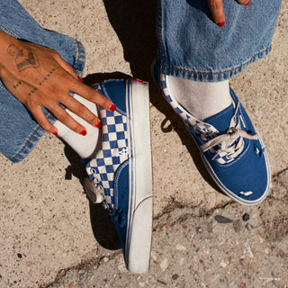 Men's low-top Vans sneakers worn, blue canvas with checkerboard side panels and laces