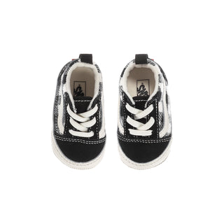Infant crib shoes with black plaid uppers, white laces, and beige interior lining