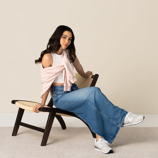 Women wearing New Balance 574 wide sneakers, beige uppers with white laces and black sole