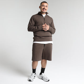 Men's brown knit shorts with elastic waistband and knee-length hem