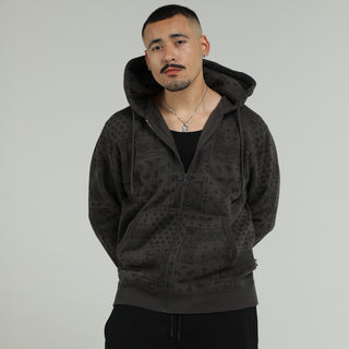 Men's dark gray patterned fleece zip hoodie with hood and zipper, worn with jeans.