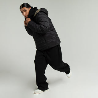 Men's black fleece open-hem pants with elastic waistband, side view