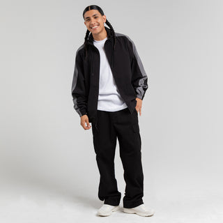 Men's black windbreaker jacket with hood and full-zip, worn over white T-shirt.