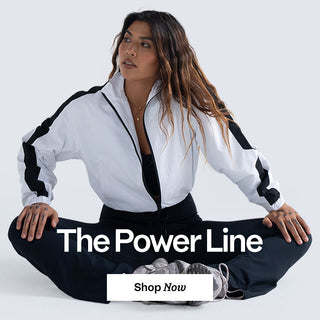 Woman sitting cross-legged wearing a white and black outfit with 'The Power Line' text.