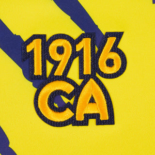 Close-up of embroidered 1916 CA lettering on the yellow tee fabric