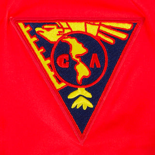 Close-up of Club America crest embroidered on a red sleeve