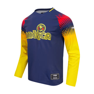 Club America long-sleeve tee shown at an angle, with front crest and bright patterned sleeves