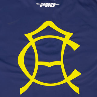 Close-up of the large yellow emblem on the navy tee