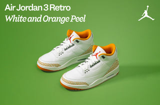 White and orange Jordan 3 Retro sneakers on a green background