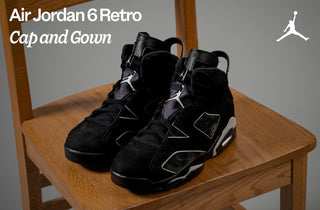 Black Air Jordan 6 Retro sneakers on a wooden chair with 'Air Jordan' logo.
