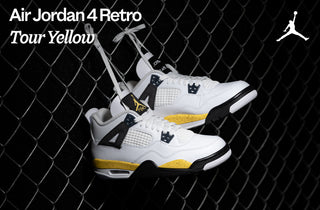Air Jordan 4 Retro Tour Yellow sneakers against a chain-link fence.