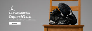 Black Air Jordan 6 Retro Cap and Gown shoes on a wooden chair with Jordan logo and text.