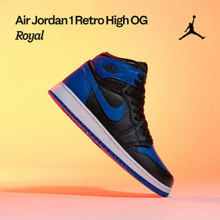 Air Jordan image: “Air Jordan 1 Retro High OG Royal sneaker in black and royal blue against a yellow-orange background.