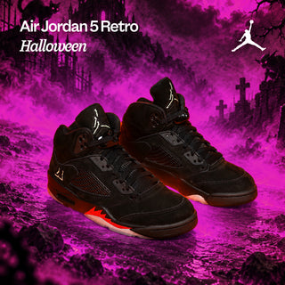 Black Air Jordan 5 Retro Halloween sneakers with orange accents against a spooky graveyard backdrop filled with purple fog.